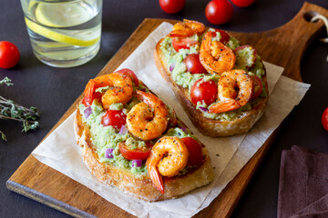 Bruschetta with shrimp, guacamole and tomatoes. Healthy eating. Breakfast.