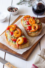 Bruschetta with shrimp, guacamole and tomatoes. Healthy eating. Breakfast.