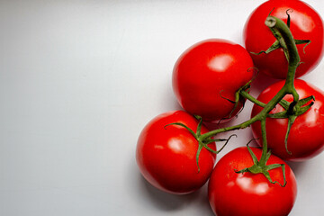 fresh red tomatoes on branch