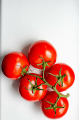 fresh red tomatoes on branch