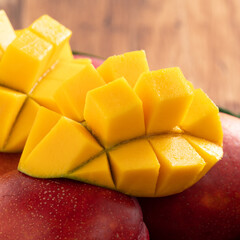 Mango. Fresh mango fruit with leaves over dark wooden table background.