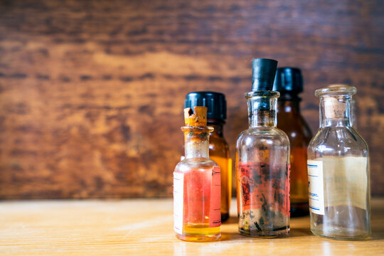 Old Medicine Bottles Standing On Shelf With Vinatge Wooden Background.