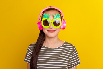 Cute girl enjoy listen music put on wireless headphone smiling perfect sound stand isolated shine background