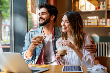 Romantic loving couple drinking coffee, having a date in the cafe.