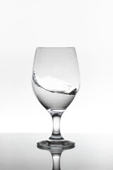 moving water inside a glass cup Isolated on white background