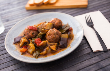 cooked meatballs with stewed eggplant with haze in bowl