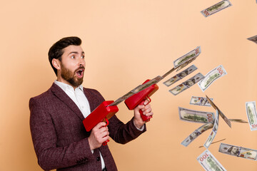 Photo of young shocked amazed surprised businessman with money gun see shopping promo isolated on...