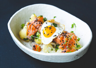 Raw salmon tartare. Fresh salmon, Katsuobushi, seasoning potatoes( Andalusian style potatoes) with white onion and parsley and fried quail egg