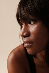 Fototapeta na wymiar Gorgeous African American woman face close up posing indoor. Vertical.