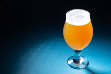Beer in glass on blue background