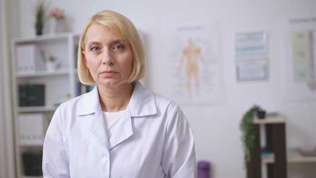 Serious female therapist looking on camera, professional health care services