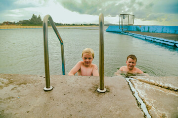 Kids swimming in the Ocean Baths swimming pool at Forster, NSW Australia