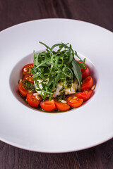 Salad with tomatoes, arugula, mozzarella and sauce