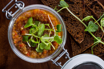 Eggplant caviar with pea sprouts in a jar and fried bread