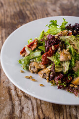 Salad with tomatoes, seeds, mushrooms, lettuce, endive