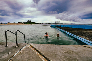 Kids swimming in the Ocean Baths swimming pool at Forster, NSW Australia