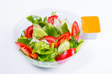 Salad with tomatoes, lettuce, cucumbers and onions