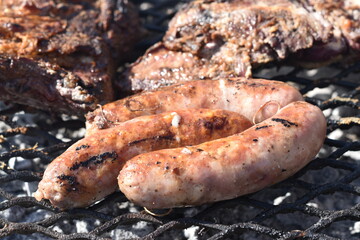 Fototapeta premium argentine meat grilled on the barbecue made with burned firewood