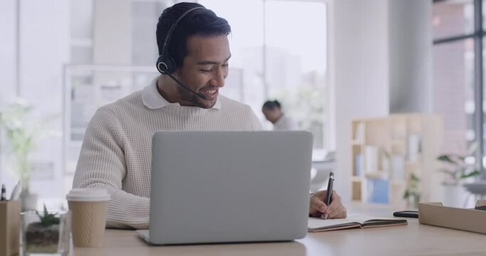 Young male call center agent talking to a customer on a call online at work. Telesales worker consulting with people on a website. Helpline advisor communicating with a client on the internet