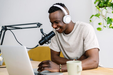Young african creator man recording radio content for his blog at home studio