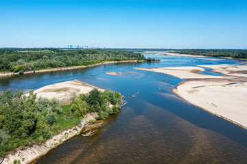 Low water level in Vistula river, effect of drought seen from the bird's eye perspective. City Warsaw in a distance.