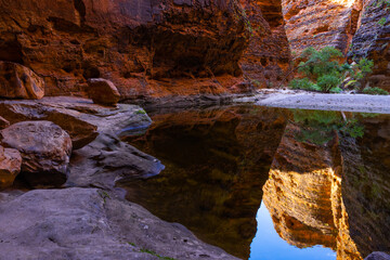 Banded beehive shaped sandstone formations reflecting in water pool in the Cathedral Gorge in the Bungle Bungle National Park, Purnululu, in the Kimberley Region of Western Australia