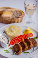 Cutlets with mashed potatoes and a glass of wine