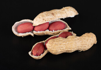 A beautiful young split peanuts in a shell with bright beautiful nuts inside and a small split...