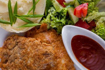 Pork chops with mashed potatoes and salad