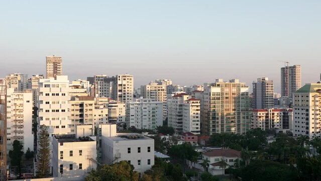 Panoramic cityscape of Santo Domingo downtown residential and office buildings in soft evening light, Dominican Republic. Static shot
