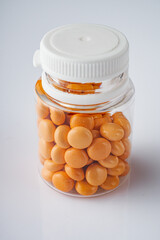 orange valerian pills on a white acrylic background