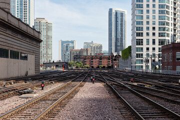 Fototapeta na wymiar Commuter train tracks cutting between buildings in downtown Chicago