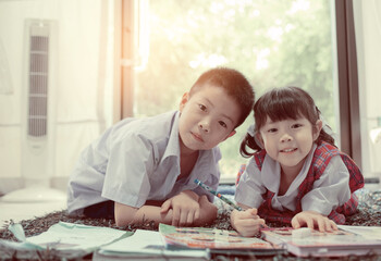 Children boy and girl doing homework together, kid write paper, learning time, student, back to school 
