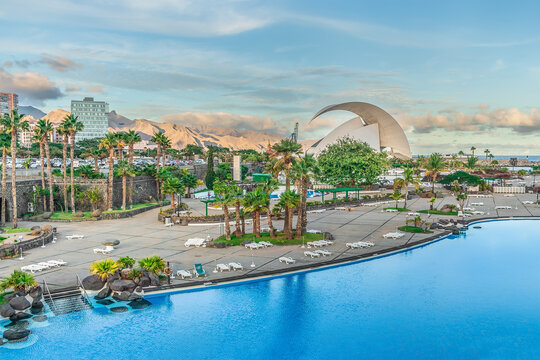 Santa Cruz de Tenerife, Spain - November 24, 2021: Exotic tropical landscape of Santa Cruz de Tenerife with Maritimo Cesar Manrique Park, Auditorio and mountains on the horizon. Resort in the Canaries