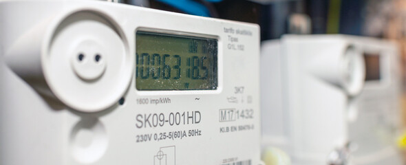 Two smart electric power meter counter measuring power usage.Banner,advertisement.Close-up of...