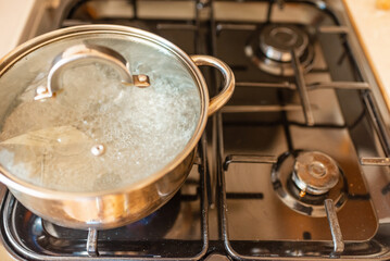 Boiling water inside a pot.Kitchen iron pot,top view,selective focus.