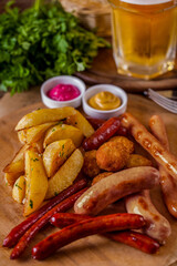 Grilled sausages with potatoes and a glass of beer