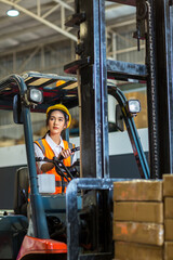 women worker at forklift driver happy working in industry factory logistic ship. Woman forklift driver in warehouse area.  © kanpisut