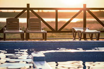 Top view of swimming pool with clear water on vacation on sunset background