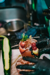 Preparation of luxury drink with strawberries and cherries
