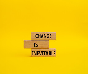 Change is Inevitable symbol. Wooden blocks with words Change is Inevitable. Beautiful yellow background. Business and Change is Inevitable concept. Copy space.