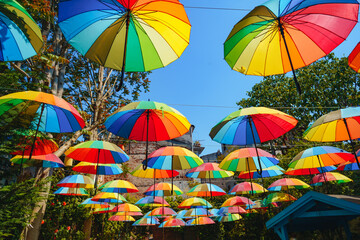 Fototapeta na wymiar Background of colorful rainbow umbrella street decoration