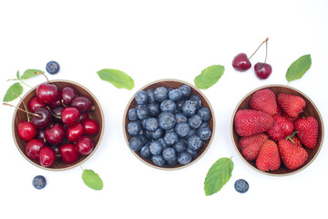 Blueberries, strawberries and cherry on white background with free space