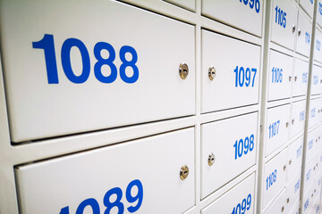 Postal office. Post boxes, storage lockers. The concept of a postman or recipient, delivery or receipt of mail from a metal store by personal number.