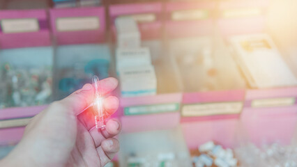 Selective focus on Pharmacist's hands taking medicines from shelf