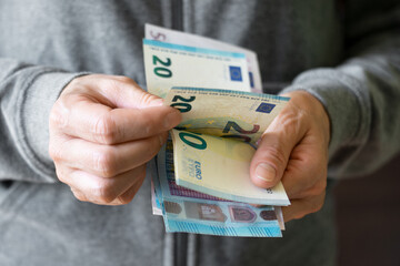 White female count euro bills in her hands - obrazy, fototapety, plakaty