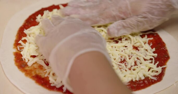 Making fresh pizza the cheese topping