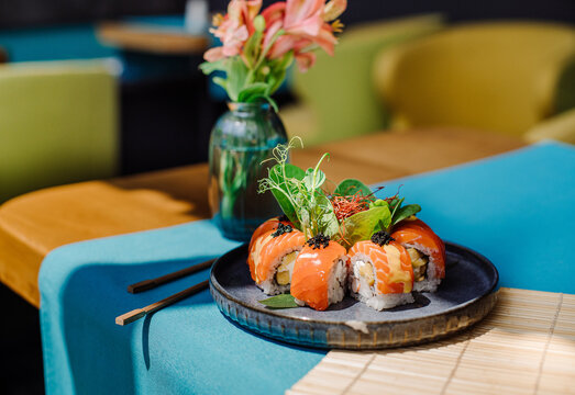 Fresh tasty sushi rolls with a salmon on the served table at the restaurant with a beautiful lightning