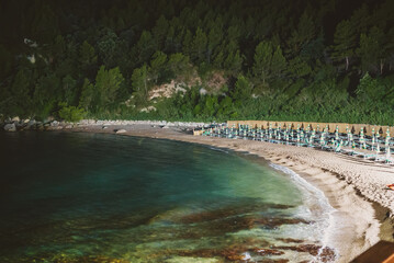 Sun loungers and umbrellas on the Sassolini beach.