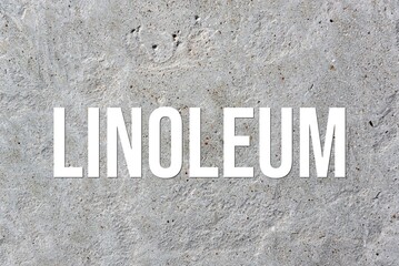 LINOLEUM - word on concrete background. Cement floor, wall.